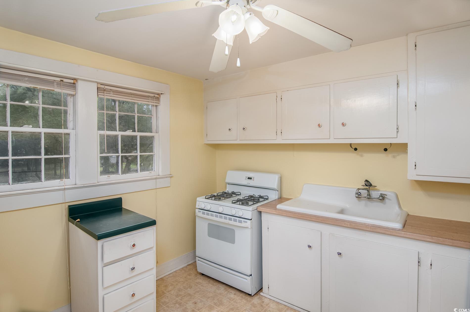 1010 Highmarket Street Georgetown, SC 29440 - Photo 26 of 32 Kitchen featuring white range with gas cooktop, white cabinets, light countertops, and a ceiling fan