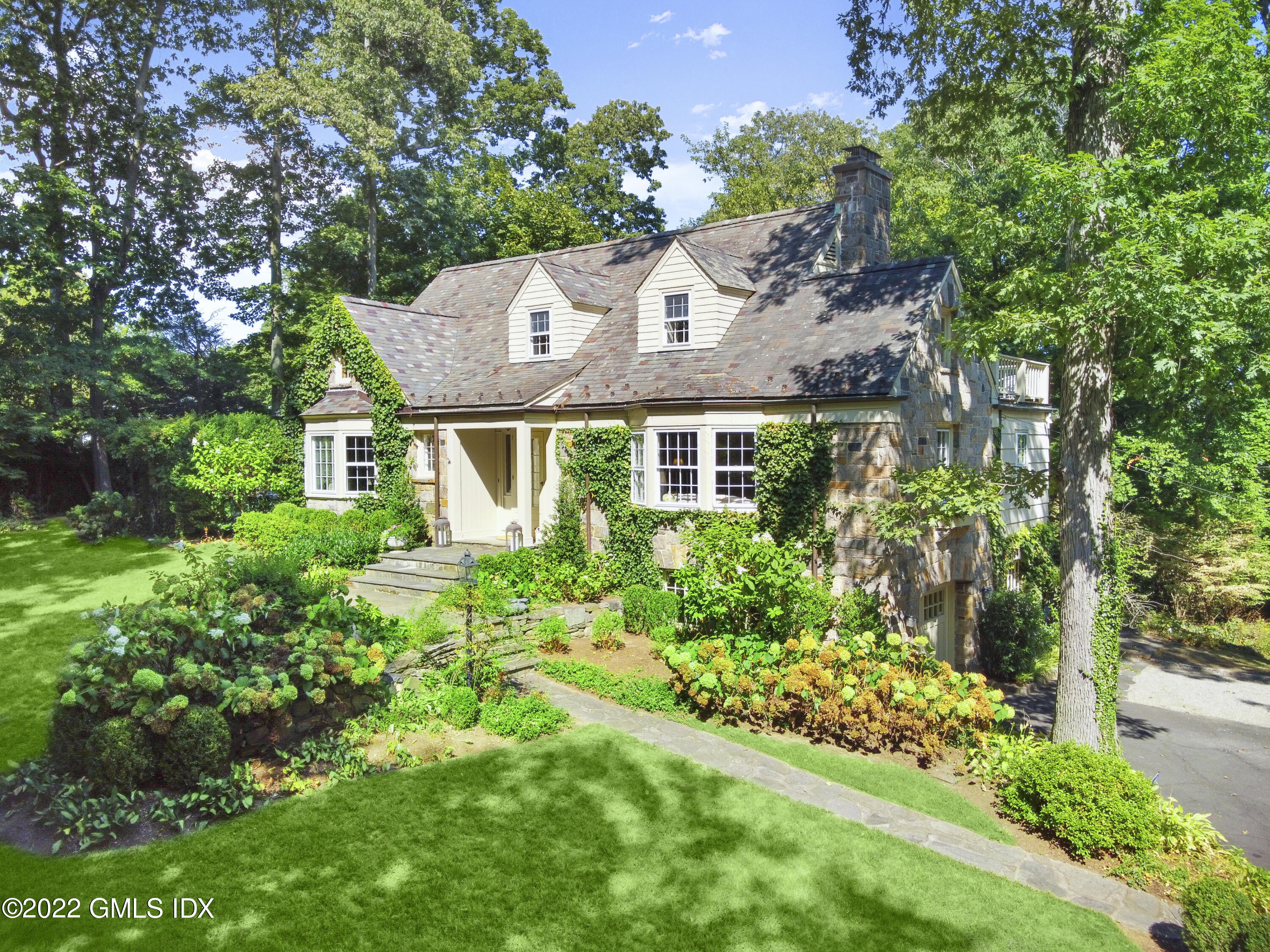 141 Hendrie Avenue Riverside, CT 06878 - Photo 1 of 34 a view of a house with a yard and garden