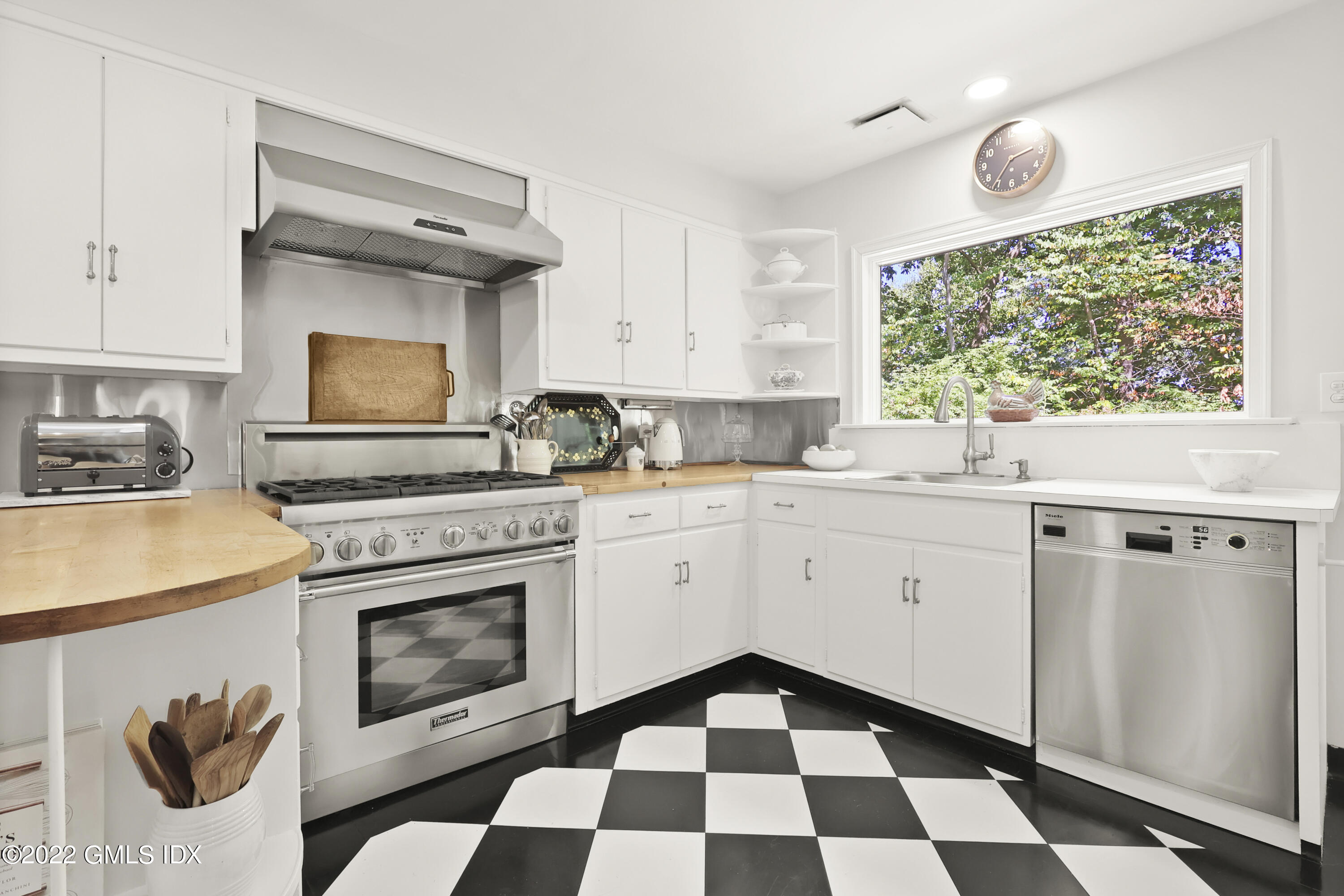 141 Hendrie Avenue Riverside, CT 06878 - Photo 12 of 34 a kitchen with a stove a sink and a window