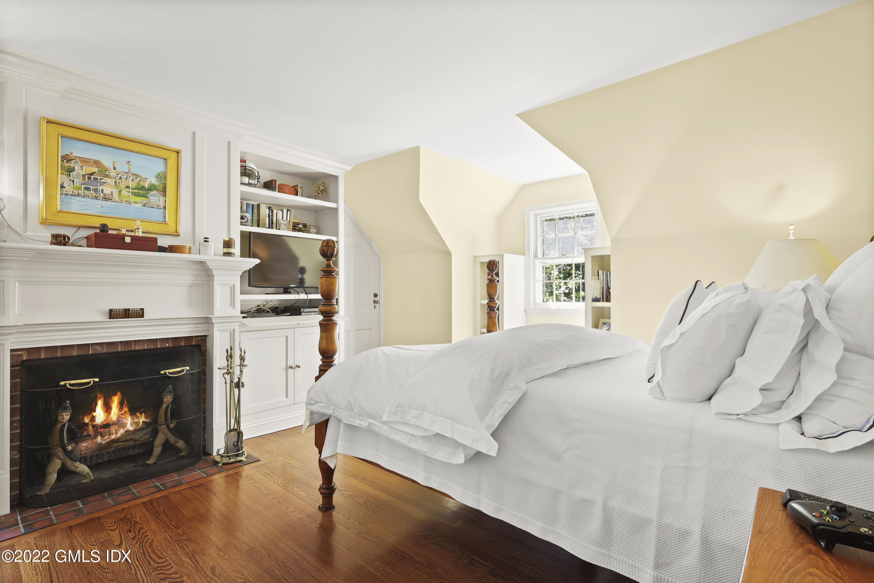 141 Hendrie Avenue Riverside, CT 06878 - Photo 25 of 34 a bedroom with a bed and a fireplace