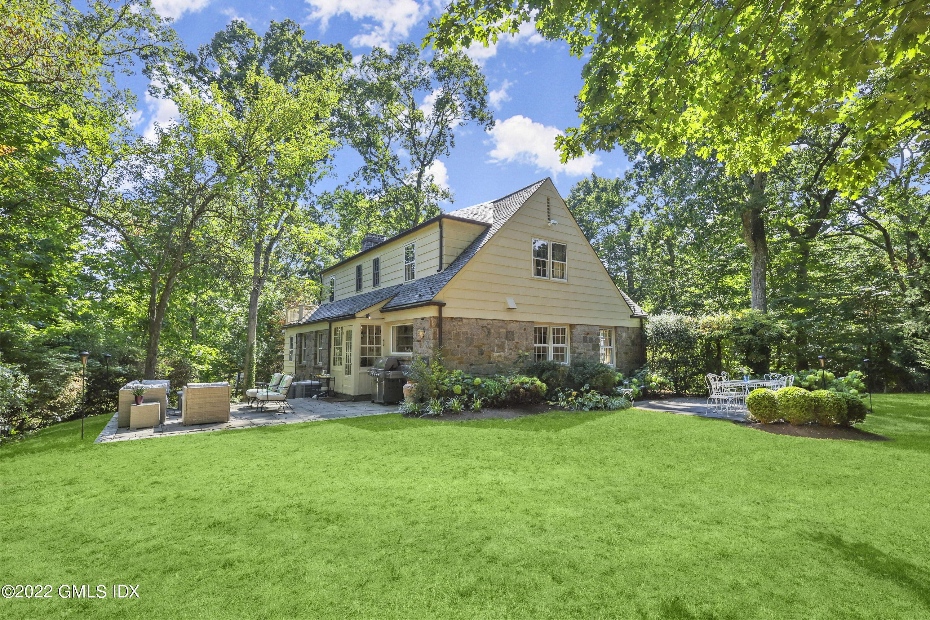 141 Hendrie Avenue Riverside, CT 06878 - Photo 3 of 34 a front view of a house with garden