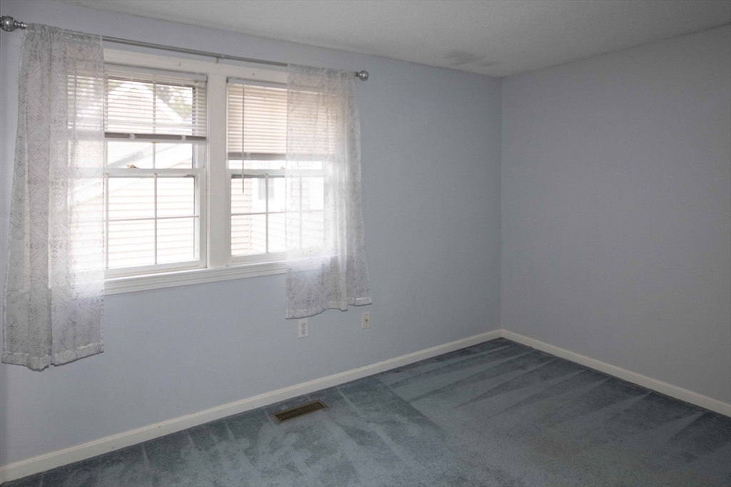 6 Winding Pond Road, Unit 6 Londonderry, NH 03053 - Photo 17 of 39 an empty room with a window