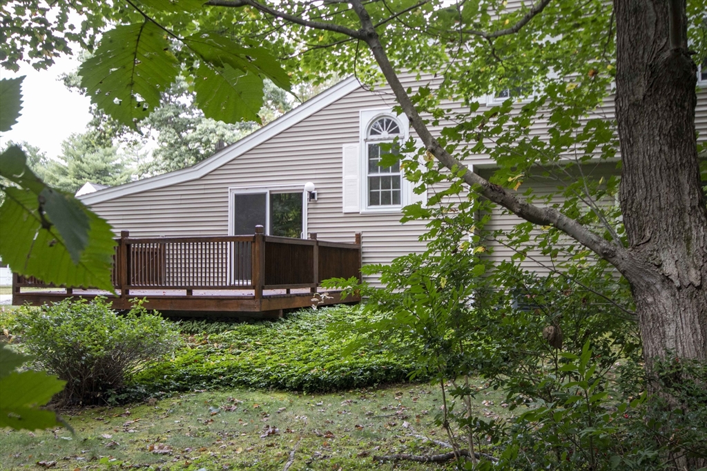 6 Winding Pond Road, Unit 6 Londonderry, NH 03053 - Photo 36 of 39 a view of a house with a yard and large trees