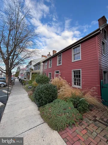 a red brick house with trees in front of it