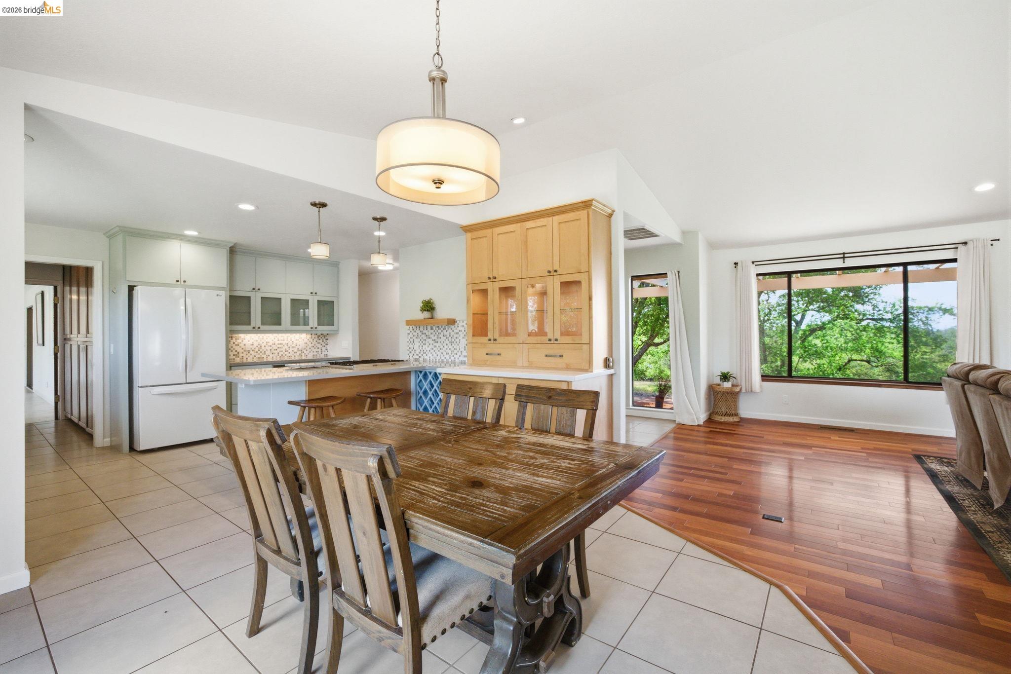 23245 Isabella Court Columbia, CA 95310 - Photo 11 of 34 a view of a dining room and livingroom with furniture wooden floor a chandelier