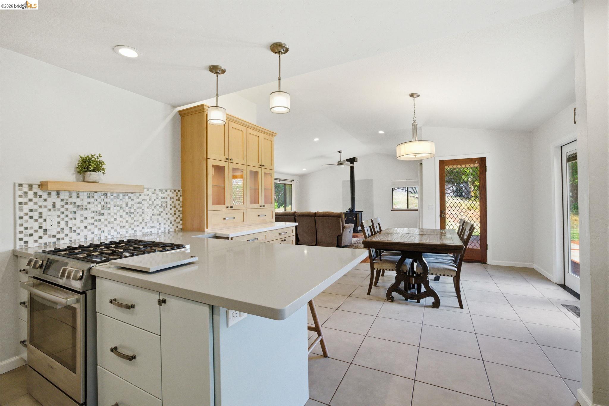 23245 Isabella Court Columbia, CA 95310 - Photo 14 of 34 a kitchen with a table chairs and white cabinets