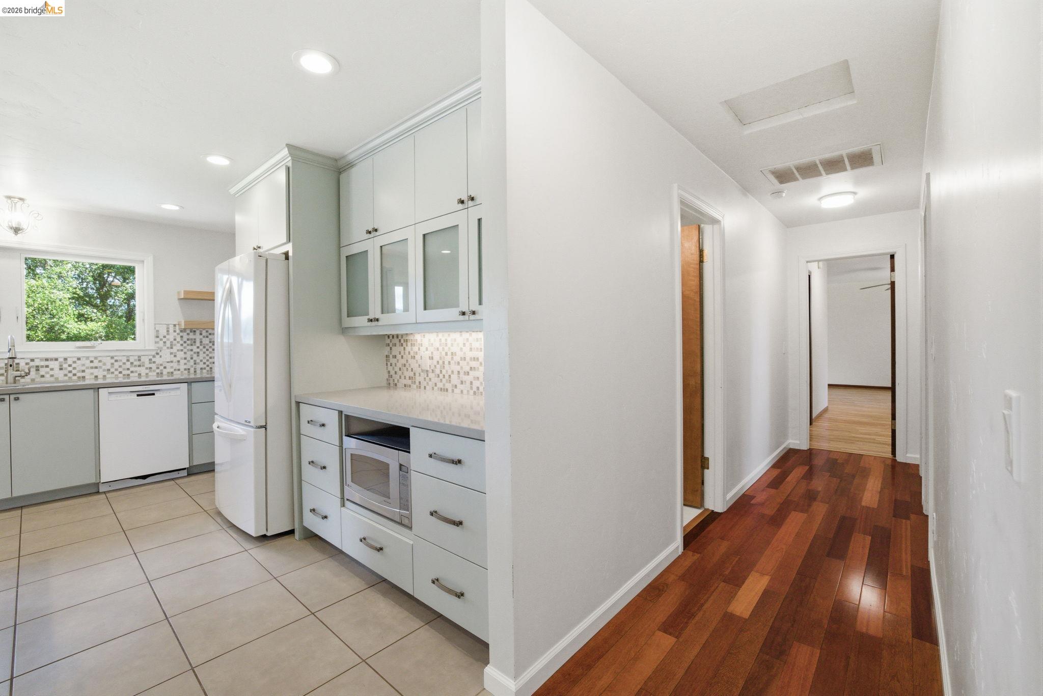 23245 Isabella Court Columbia, CA 95310 - Photo 17 of 34 a kitchen with white cabinets and wooden floor
