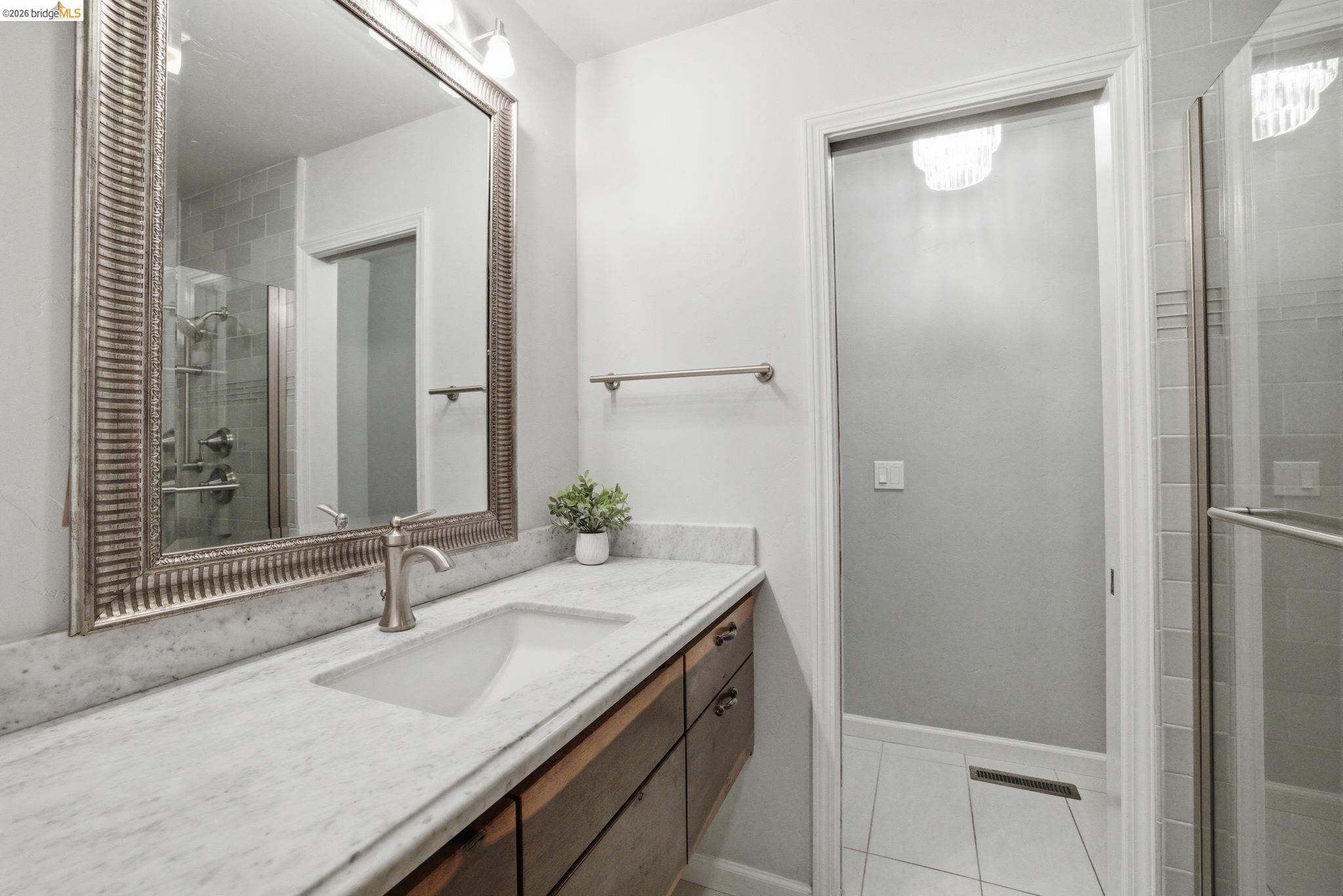 23245 Isabella Court Columbia, CA 95310 - Photo 19 of 34 a bathroom with a granite countertop sink and a mirror
