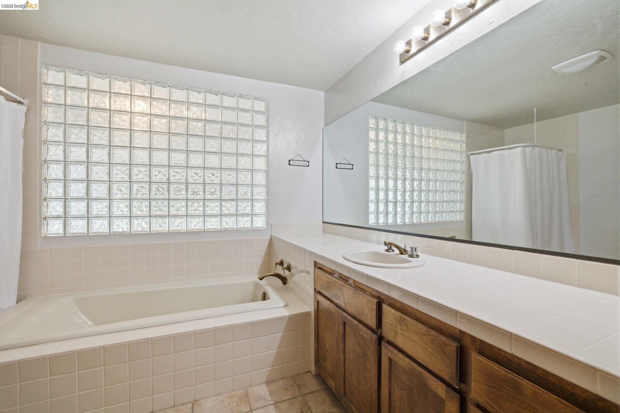 23245 Isabella Court Columbia, CA 95310 - Photo 20 of 34 a bath room with a bath tub and a shower