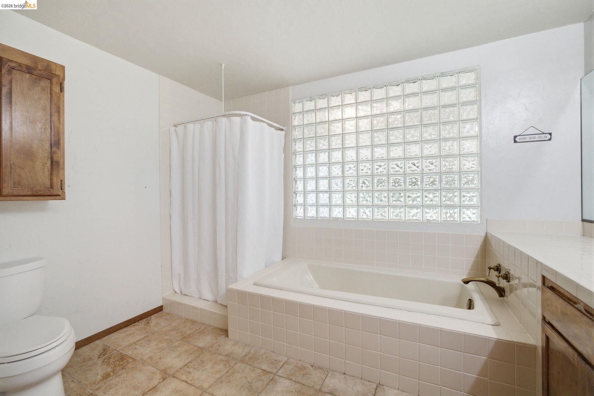 23245 Isabella Court Columbia, CA 95310 - Photo 21 of 34 a white bath tub sitting next to a toilet