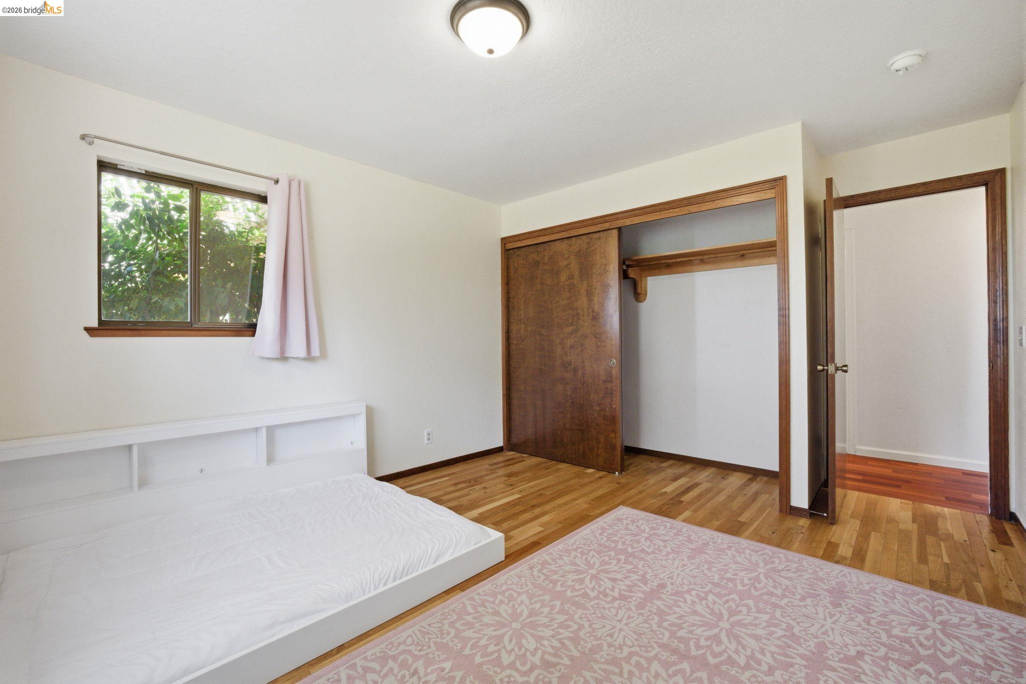23245 Isabella Court Columbia, CA 95310 - Photo 23 of 34 an empty room with wooden floor and windows