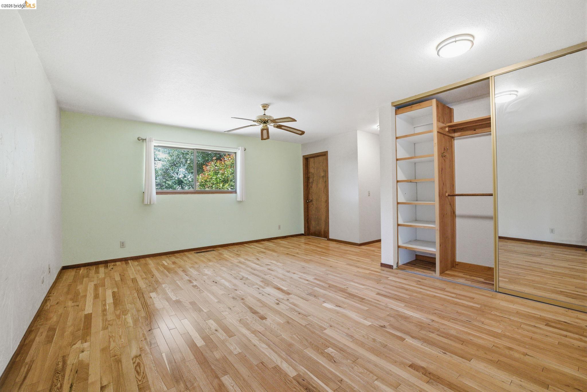 23245 Isabella Court Columbia, CA 95310 - Photo 26 of 34 an empty room with wooden floor and windows