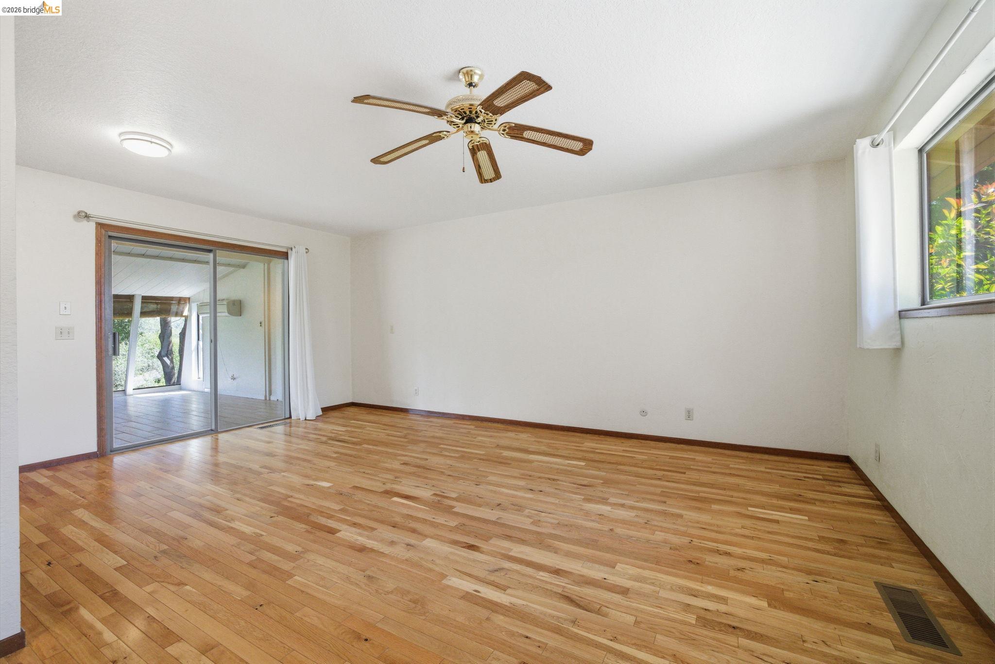 23245 Isabella Court Columbia, CA 95310 - Photo 27 of 34 a view of empty room with wooden floor and fan