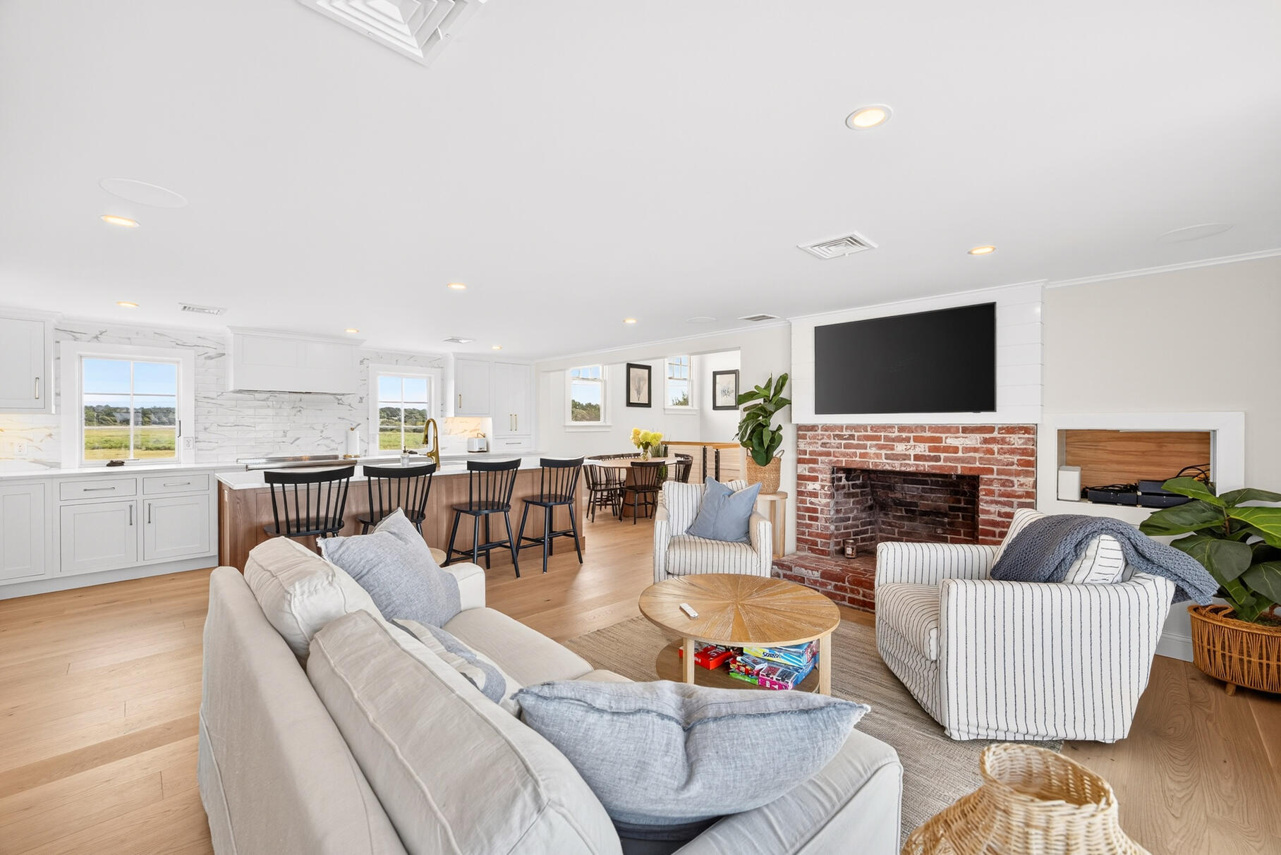 65 Harmes Way Eastham, MA 02642 - Photo 11 of 35 a living room with fireplace furniture and a flat screen tv