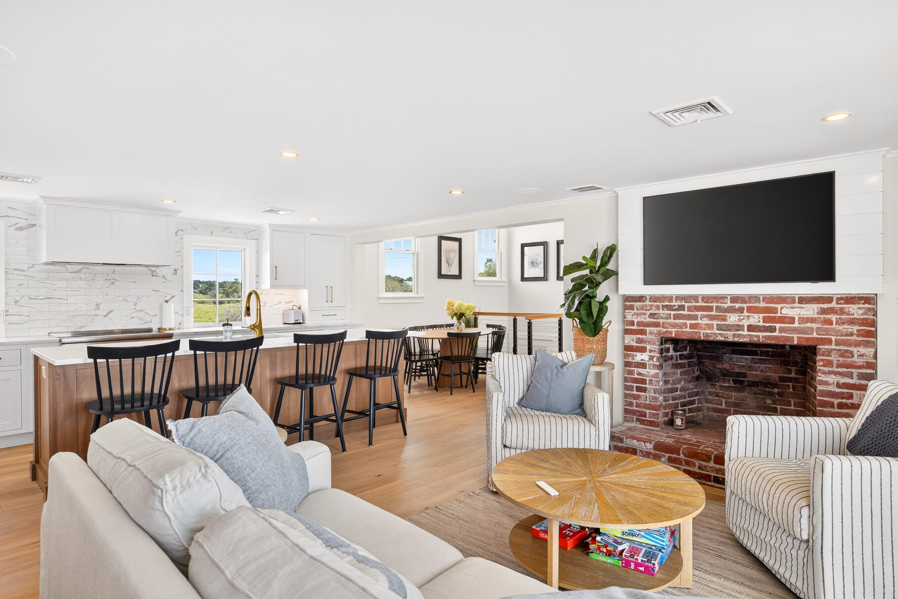 65 Harmes Way Eastham, MA 02642 - Photo 12 of 35 a living room with furniture a fireplace and a flat screen tv