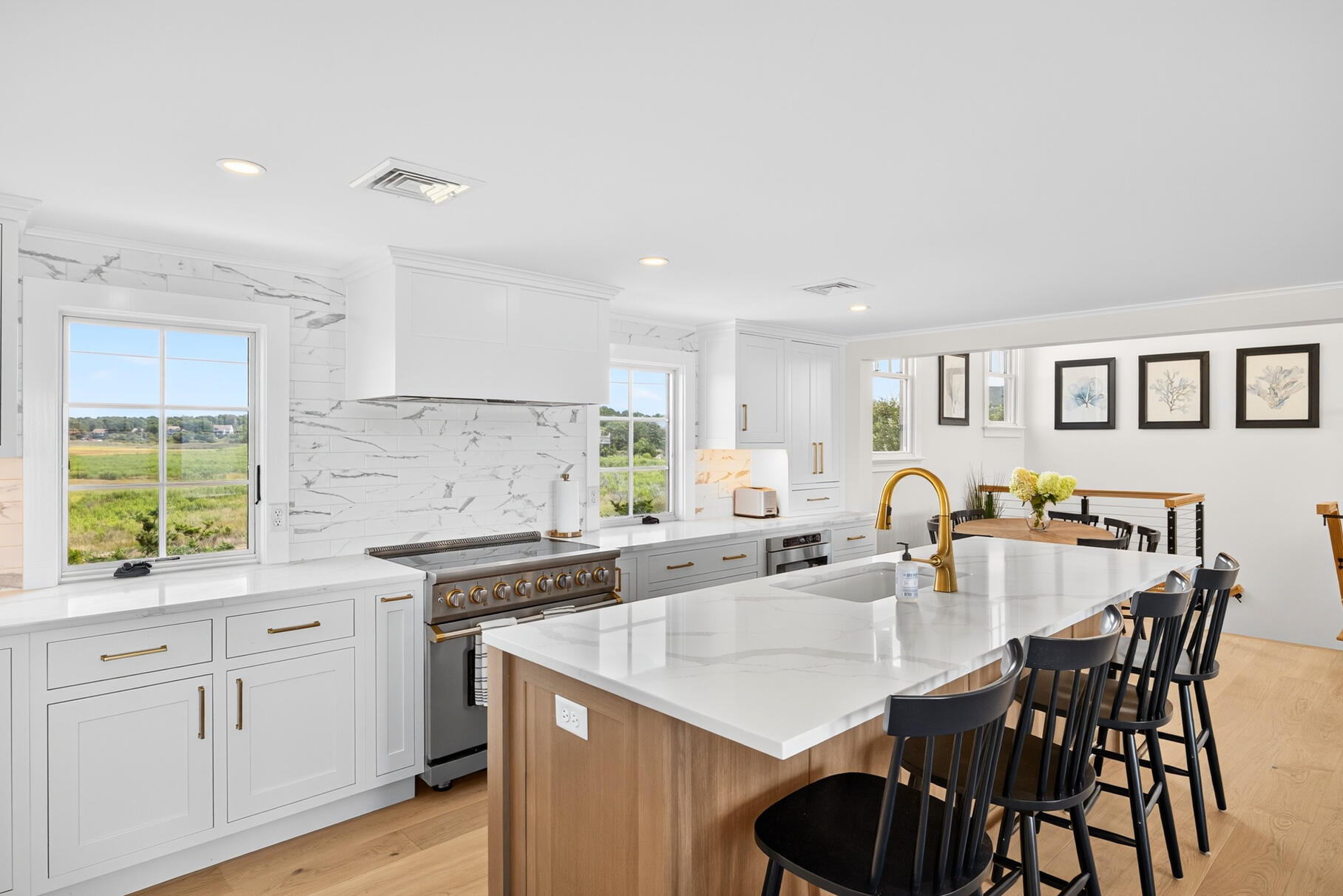 65 Harmes Way Eastham, MA 02642 - Photo 4 of 35 a kitchen with kitchen island granite countertop a table chairs sink and cabinets