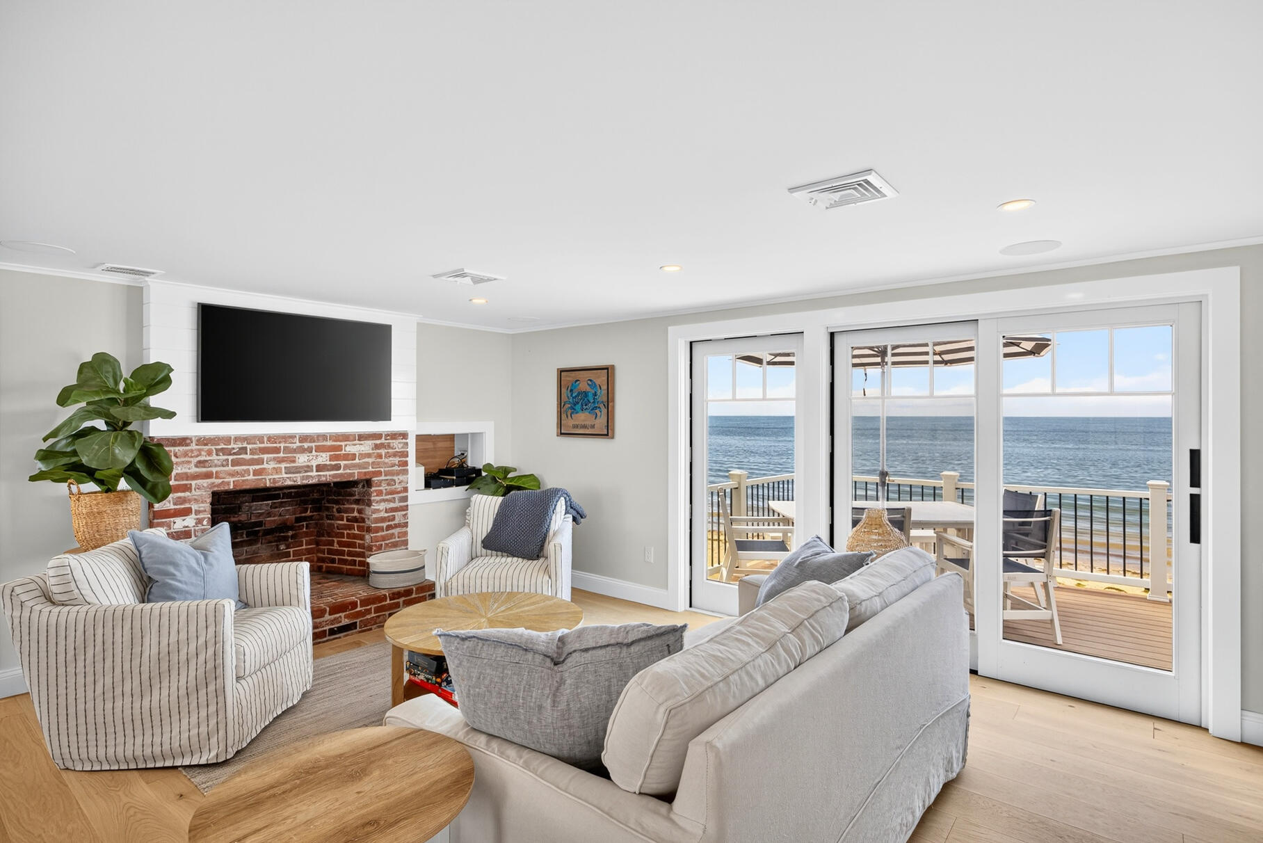 65 Harmes Way Eastham, MA 02642 - Photo 7 of 35 a living room with furniture a large window and a fireplace