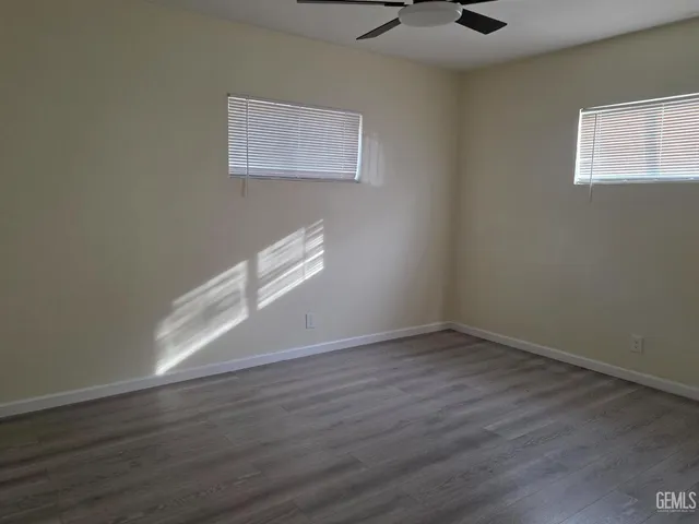 an empty room with a empty space and windows
