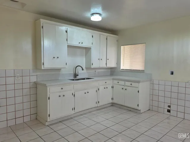 a kitchen with white cabinets