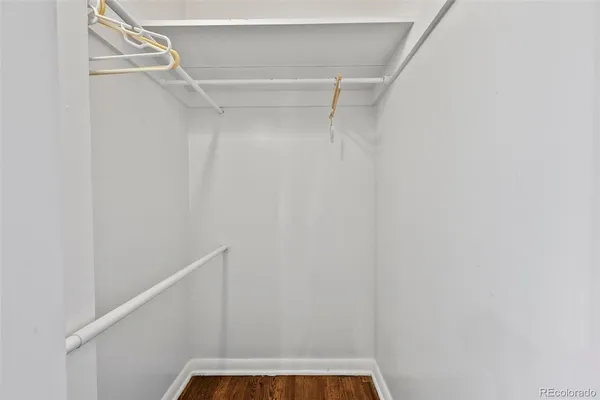 a view of walk in closet with empty racks
