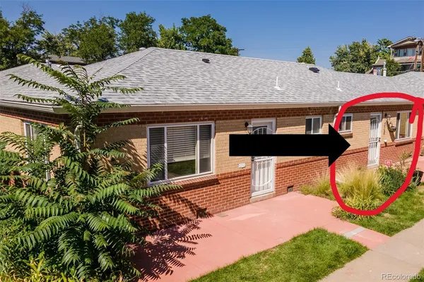 a backyard of a house with barbeque oven and outdoor seating