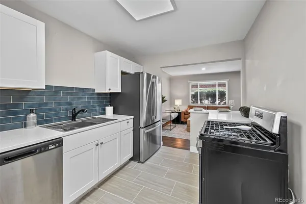 a kitchen with a sink stove and refrigerator