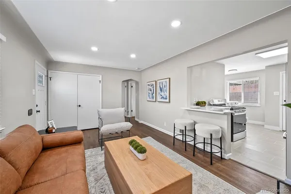 a living room with furniture and a wooden floor