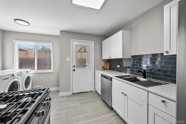 a kitchen with stainless steel appliances granite countertop a sink stove and cabinets