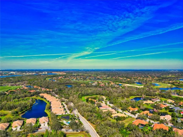 an aerial view of residential houses with outdoor space and swimming pool