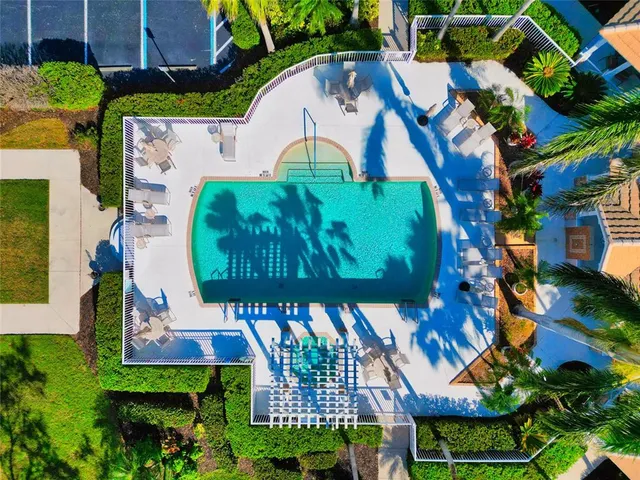 an aerial view of a house with a garden and swimming pool