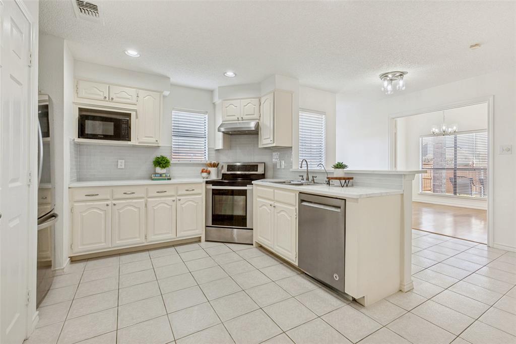 703 Rams Court Richardson, TX 75081 - Photo 8 of 23 Kitchen opens to breakfast area and dining room. Dining room can be closed off with french doors.
