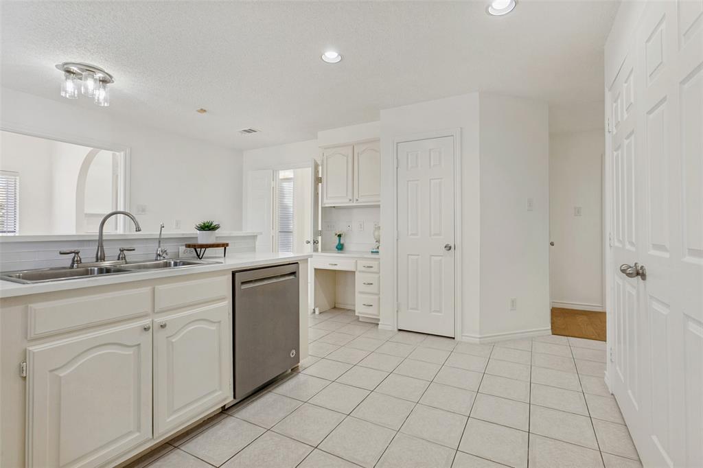 703 Rams Court Richardson, TX 75081 - Photo 10 of 23 Kitchen with built-in desk and pantry.