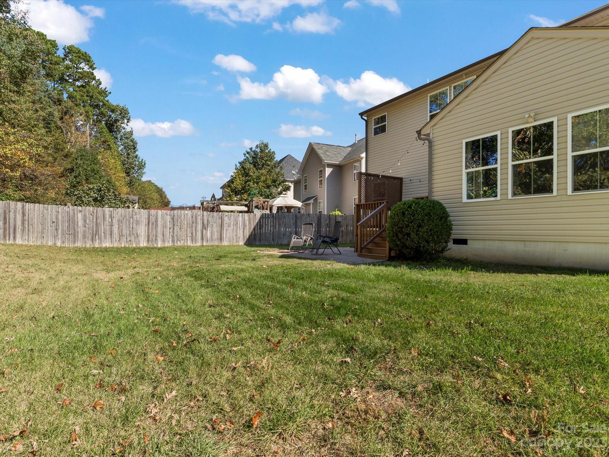 7634 West Berkeley Road Denver, NC 28037 - Photo 23 of 25 a view of a house with backyard and a garden