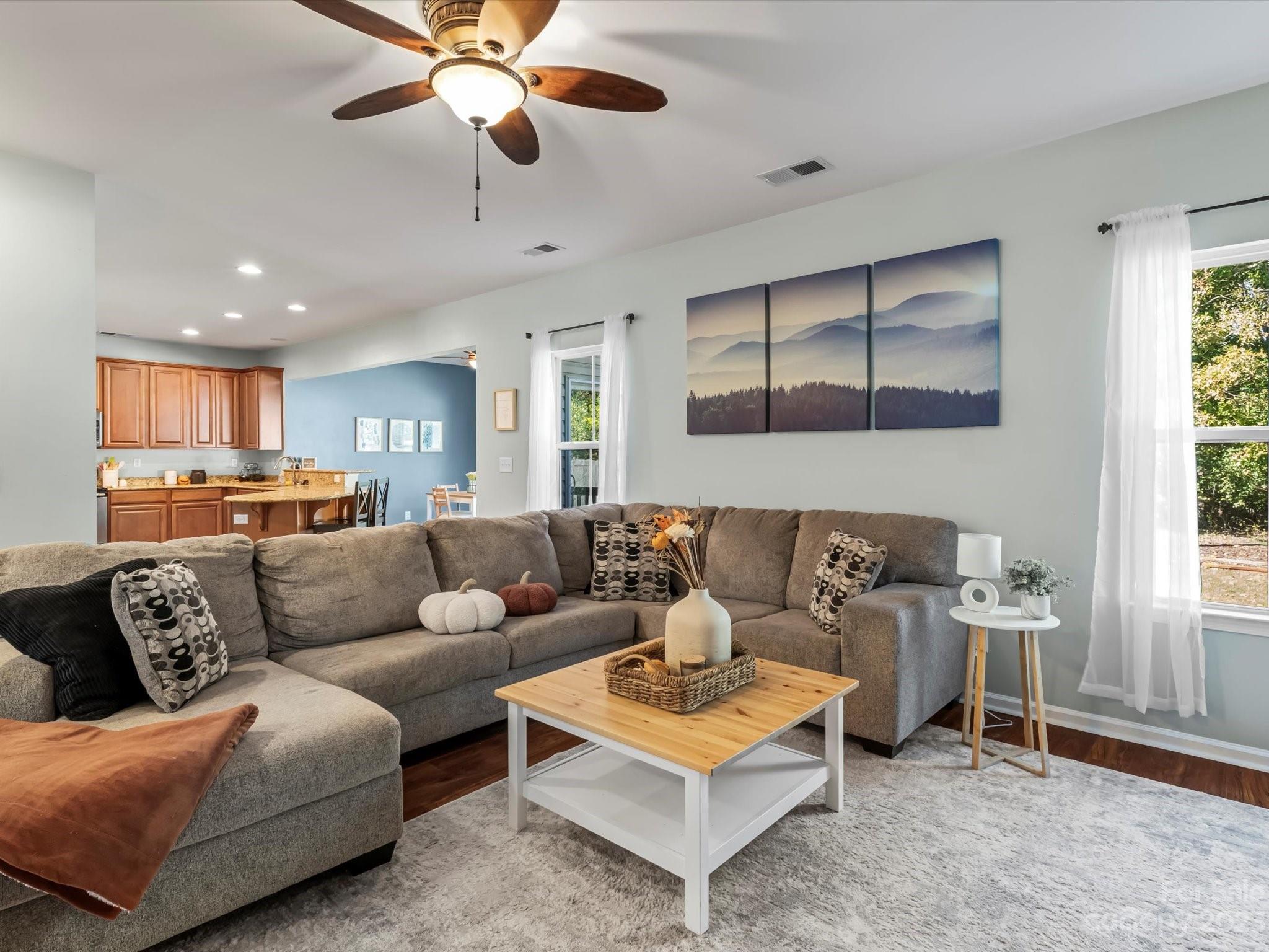 7634 West Berkeley Road Denver, NC 28037 - Photo 3 of 25 a living room with furniture ceiling fan and a window