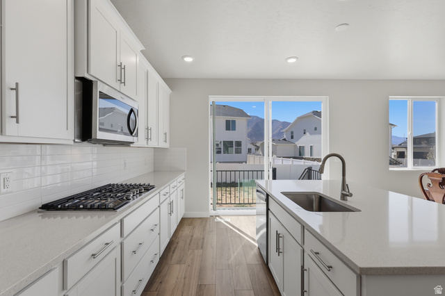 1353 Mapleton Hts Court Mapleton, UT 84664 - Photo 6 of 50 View 2 Kitchen featuring white cabinets, light stone counters, a kitchen island with sink, light wood-style floors, and recessed lighting