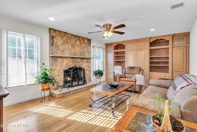 a living room with furniture a fireplace and a large window