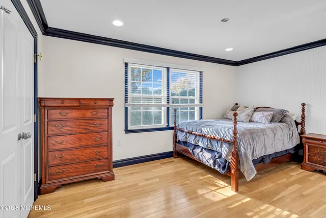 a spacious bedroom with a bed and a window