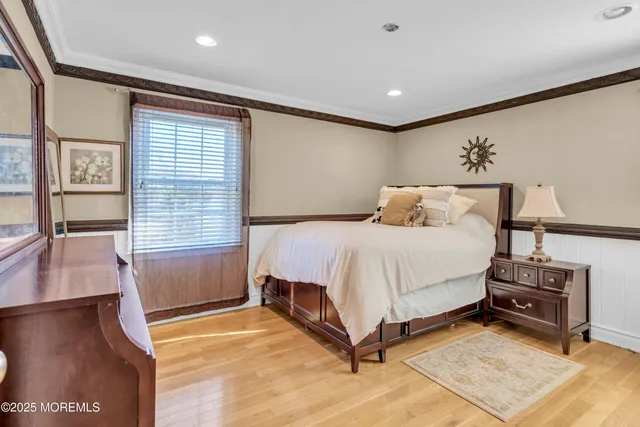 a spacious bedroom with a bed and a night stand