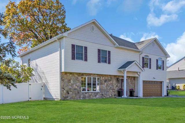 a front view of a house with a garden and yard