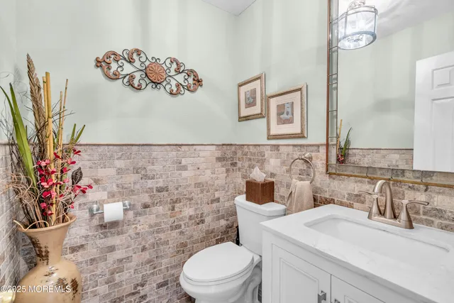 a bathroom with a sink mirror vanity and toilet