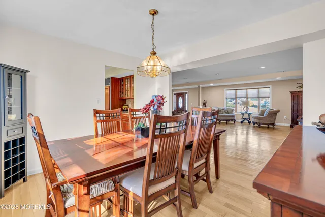 a dining room with furniture window and wooden floor
