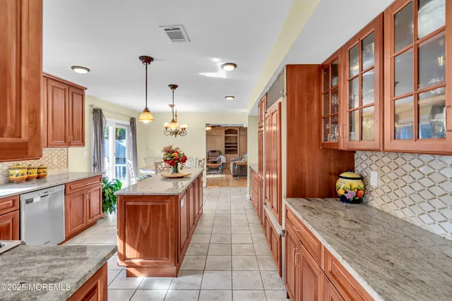 a kitchen with stainless steel appliances granite countertop sink stove and refrigerator