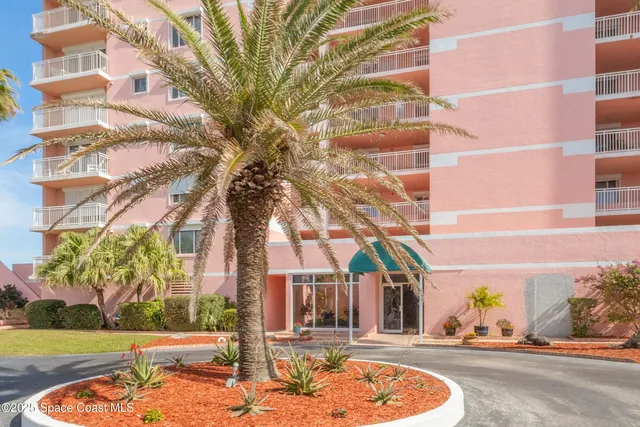 a living room with couches a flat screen tv and a large window