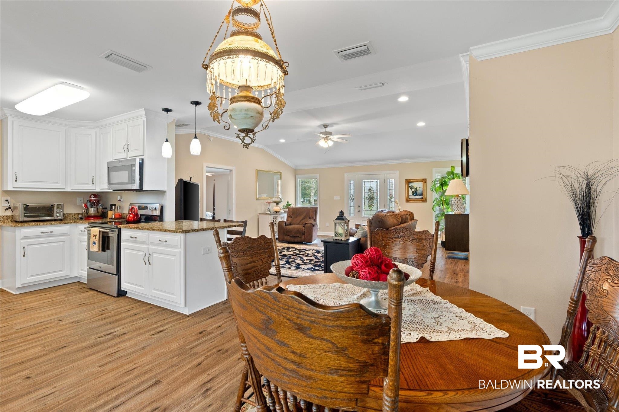 734 West Section Avenue Foley, AL 36535 - Photo 13 of 50 Dining space with visible vents, light wood finished floors, and ornamental molding