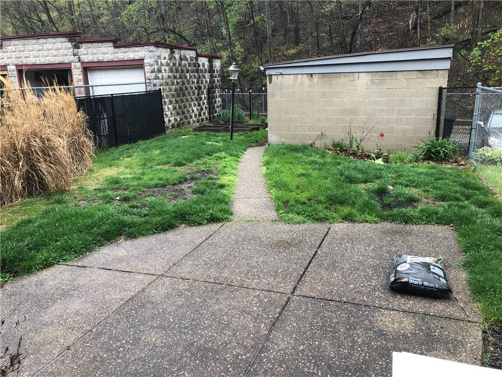 1224 Evergreen Road Pittsburgh, PA 15209 - Photo 14 of 20 Fully fenced in backyard with raised garden beds and concrete patio off the porch.