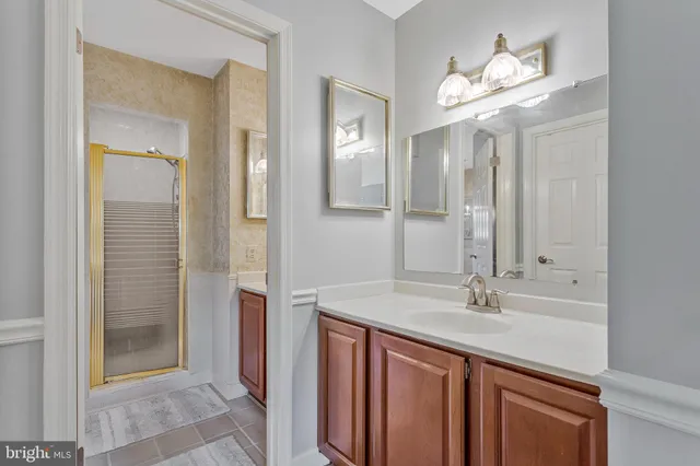 a bathroom with a sink double vanity and a shower