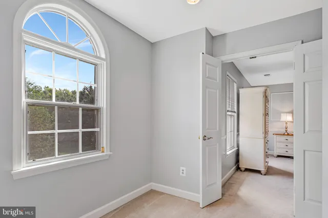 an empty room with windows and closet