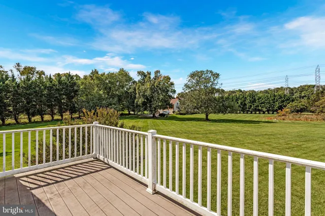 a view of a wooden deck with a yard