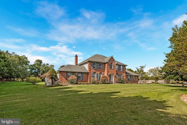 a front view of a house with a big yard