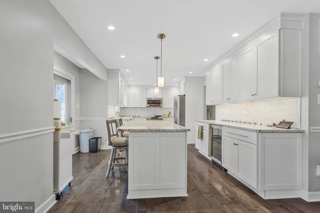 a kitchen with a stove a sink and a refrigerator